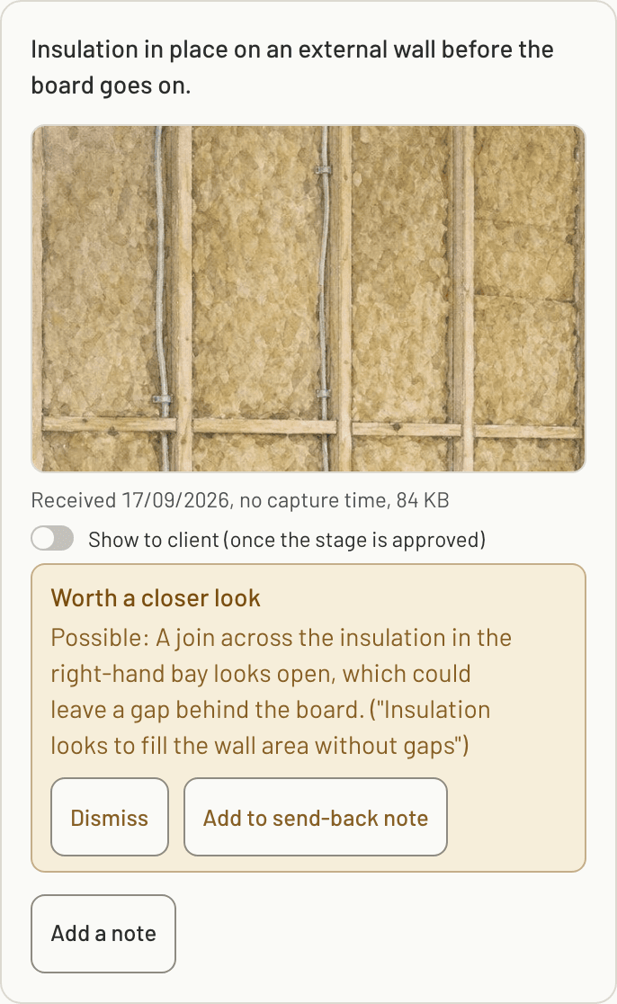 A flagged photo in the builder's review: insulation between timber studs marked worth a closer look, with a possible open join in the right-hand bay and the shot's own criterion quoted